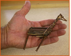 Twig figurine that looks like a deer (replica).