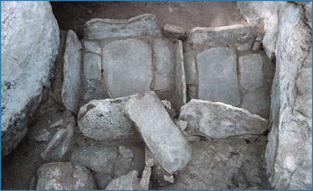 Slab metates in metate bins.